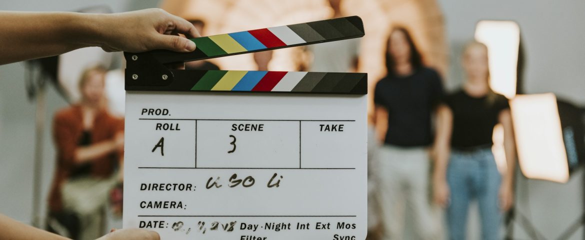 Woman holding a movie production clapperboard